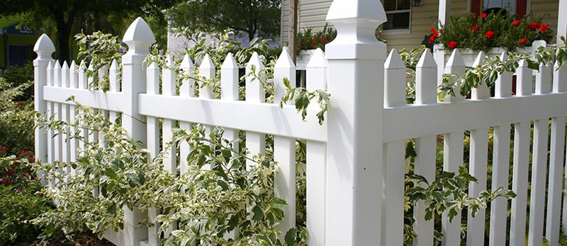 Wholesale fence distributors; white fence around a garden