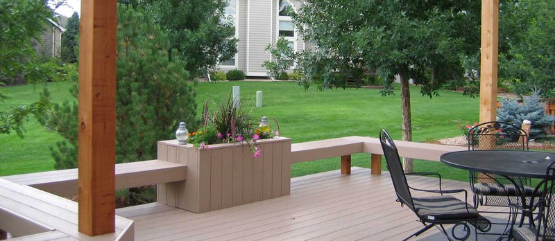 A beautiful view of a house backyard with a deck made from the best composite decking materials