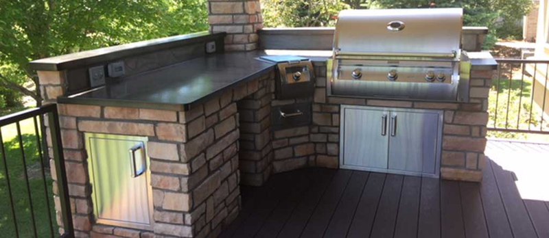 One example of our custom outdoor kitchens with a sink, grill, countertops, cabinets, and more.