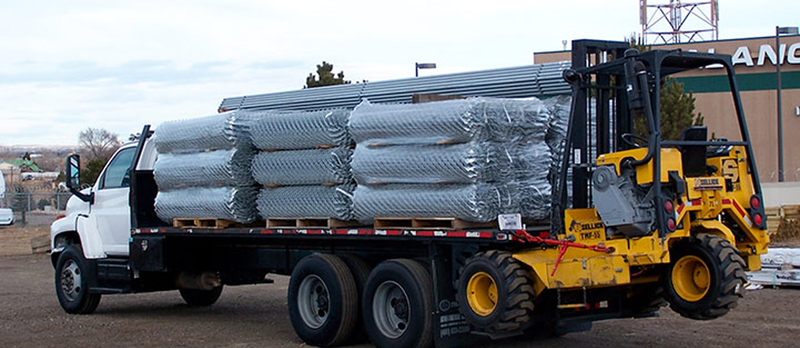 Commercial chain link fence being transported on a truck