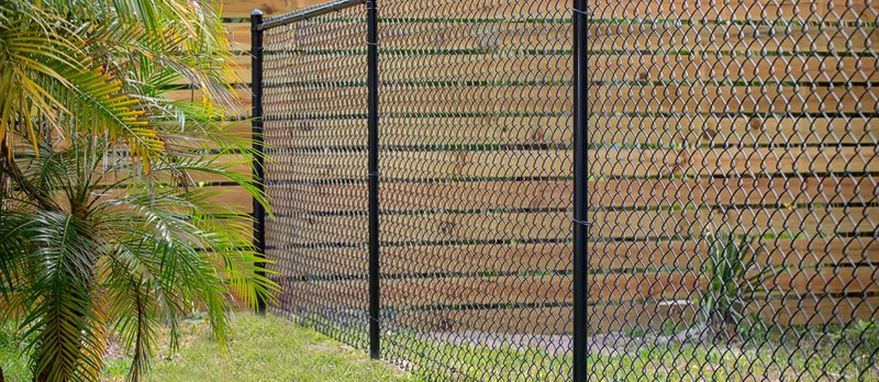 This black chain secured the chain link fence to the ground, providing additional stability.